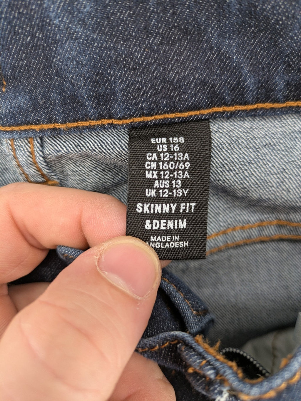 H&M blue skinny fit jeans with classic 5-pocket style and button closure.