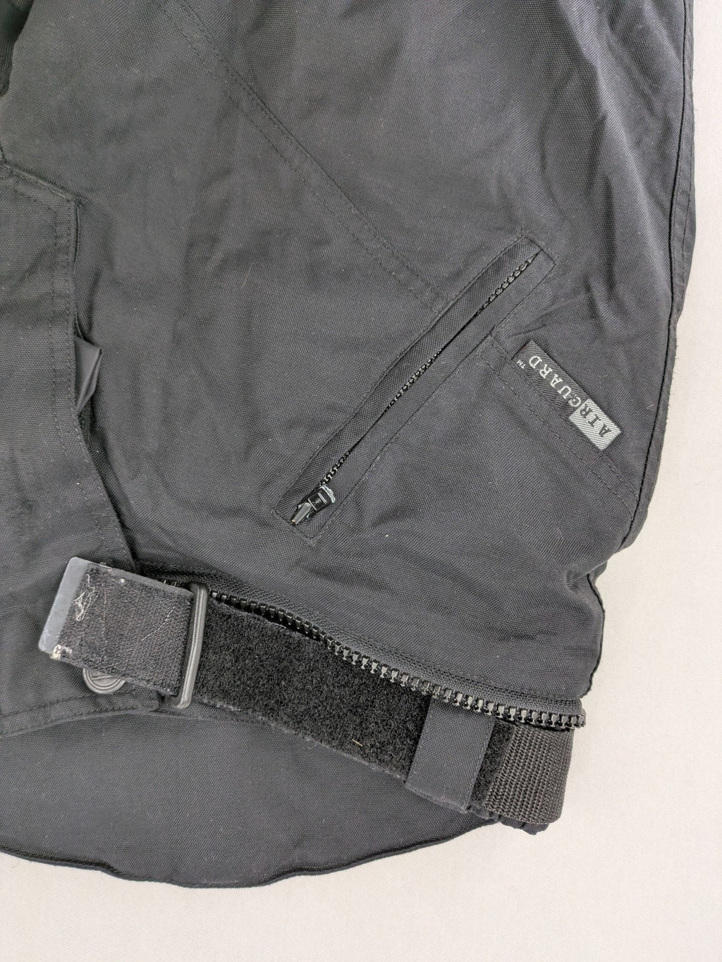 iXS black chaps with grey accents, waterproof textile, adjustable belt, reinforced knees.