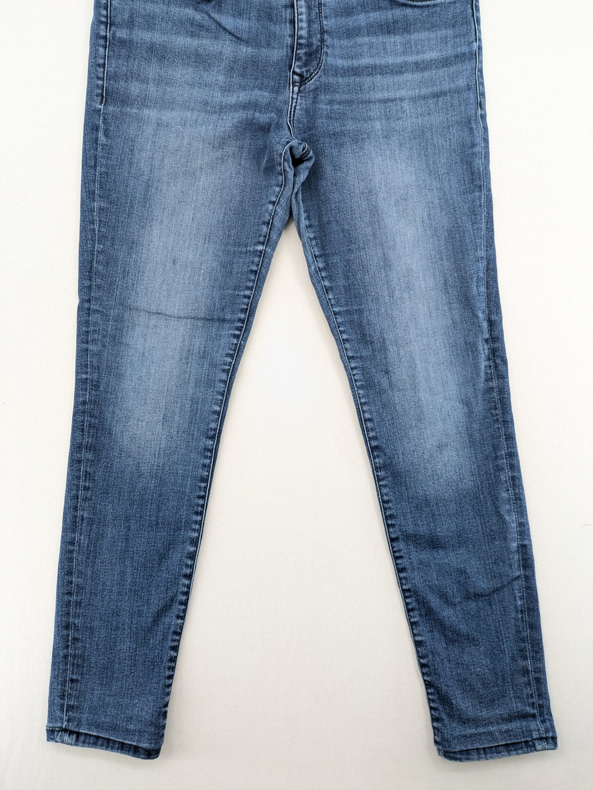 Mavi blue high rise super skinny jeans with medium wash and stretch denim material.