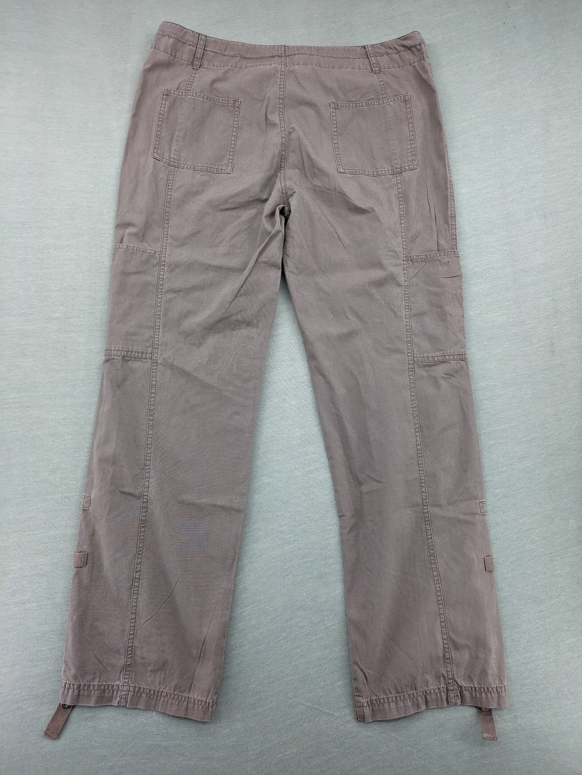 Columbia grey cargo pants with multiple pockets and drawstring waist, 100% cotton.