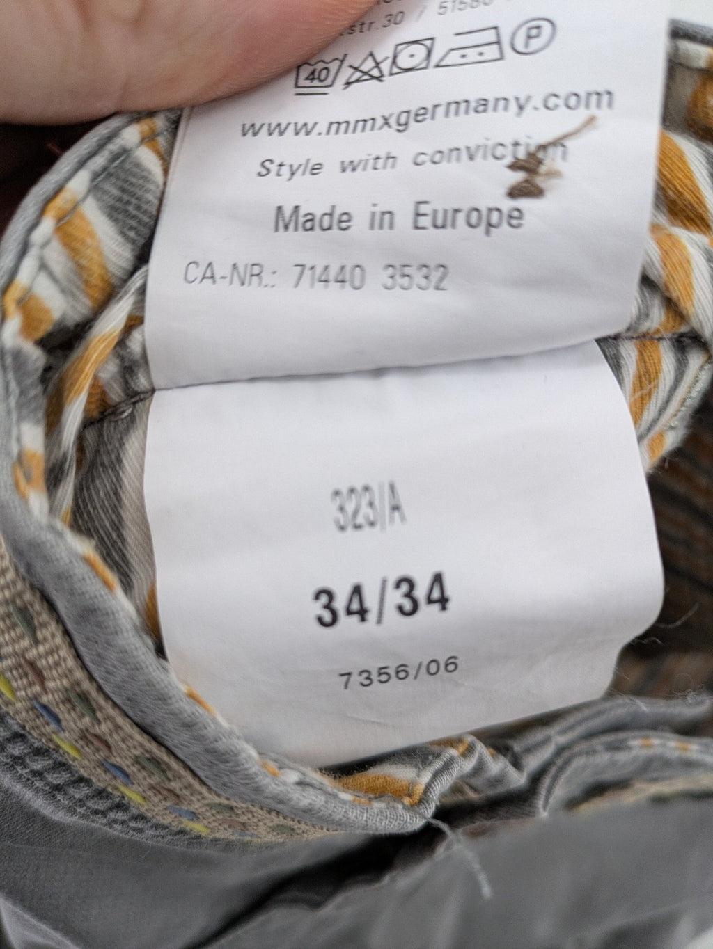 MMX grey chino pants with patterned interior lining and contrasting waistband, made from organic cotton.