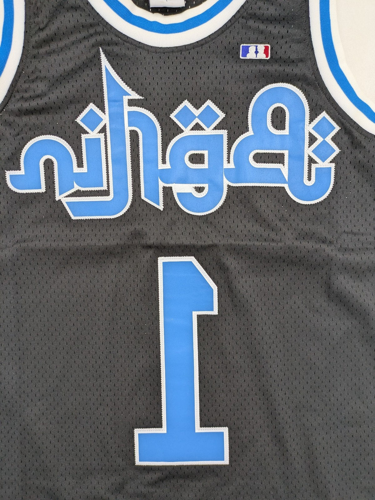 Friends With Money blue basketball jersey black mesh with stylized graphic and number "1
