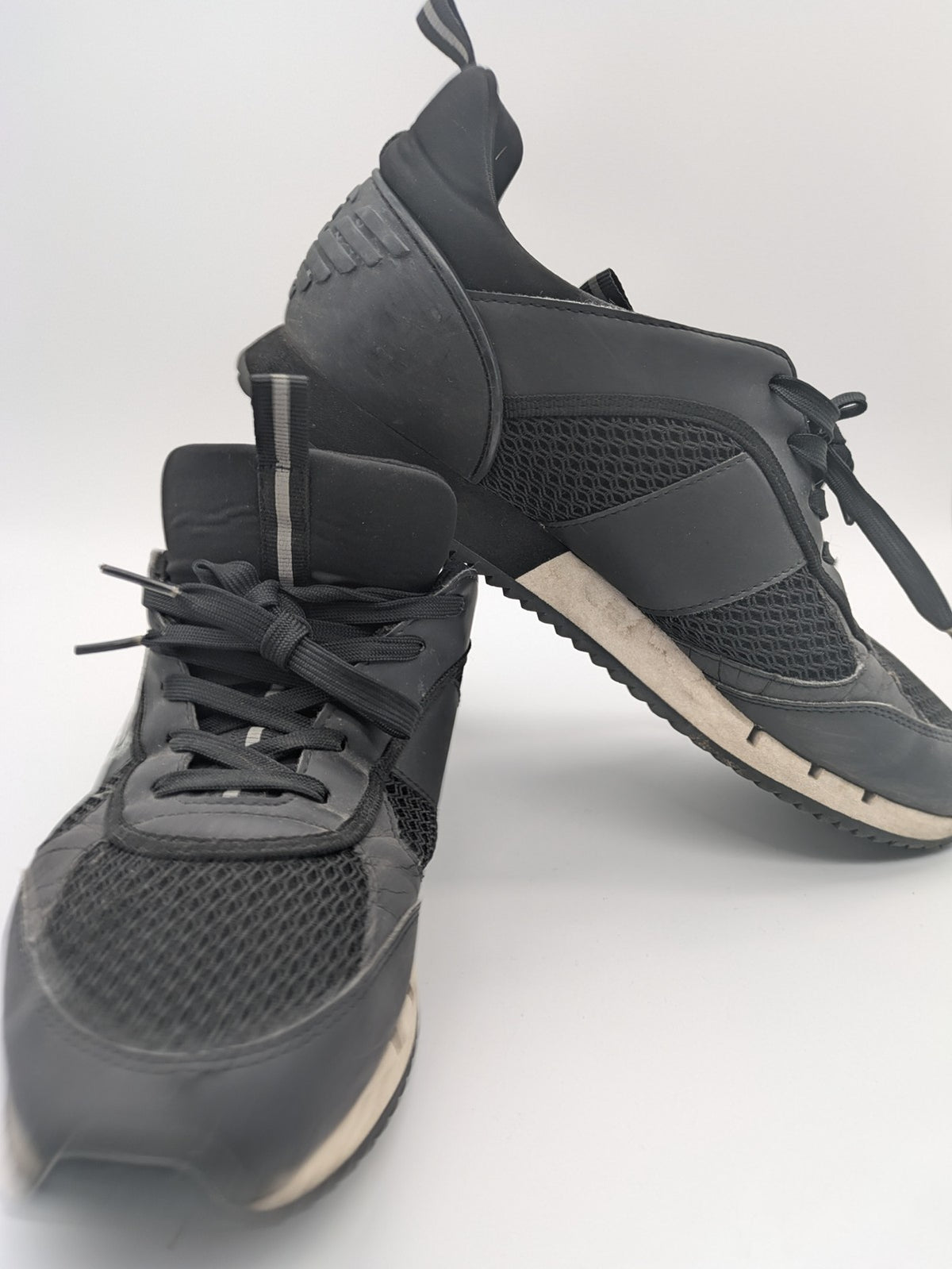EA7 Emporio Armani beige and black sneakers with prominent EA7 branding and breathable mesh details.