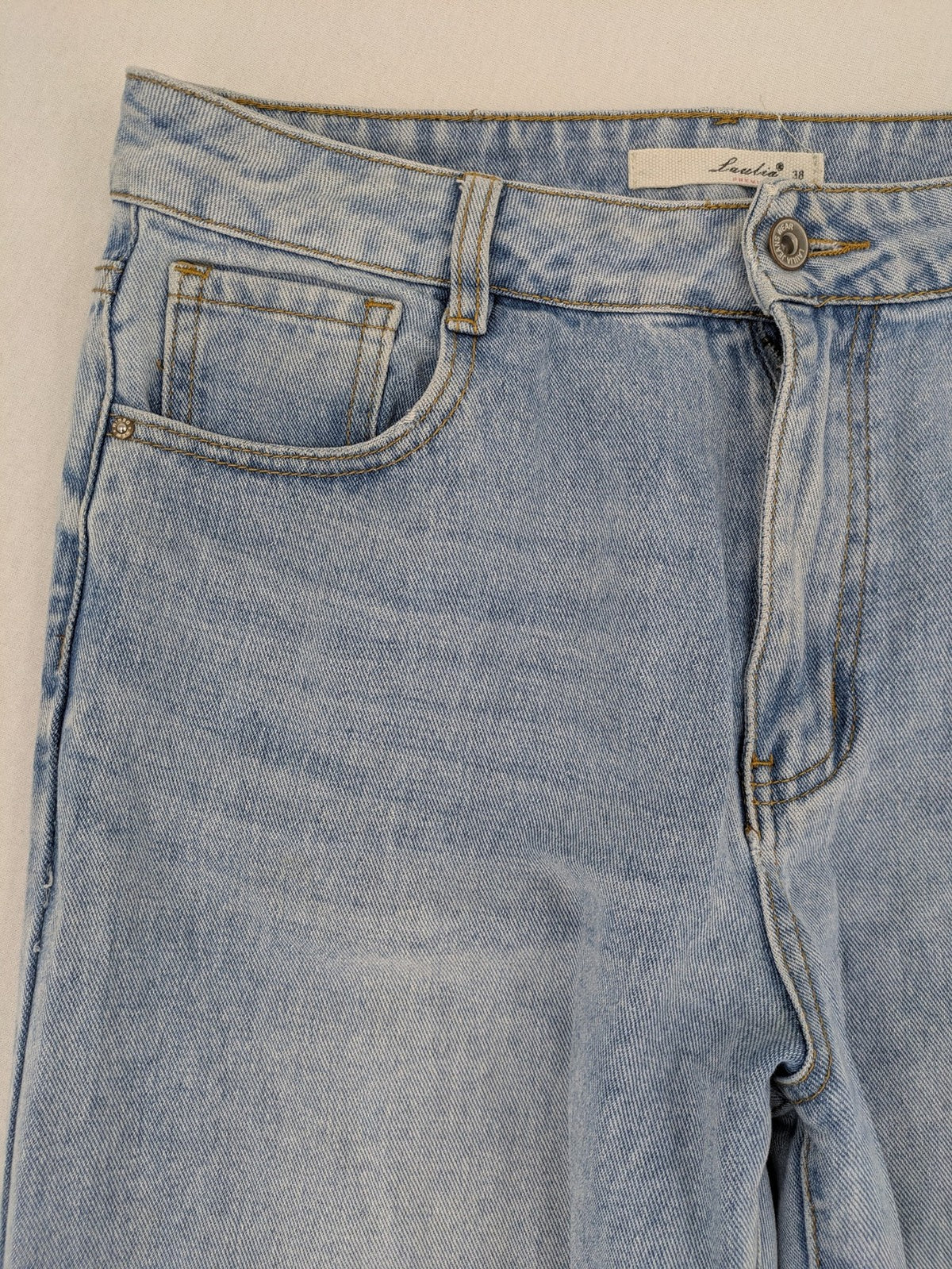 Laulia blue wide leg jeans with distressed knee rips and high waist design.