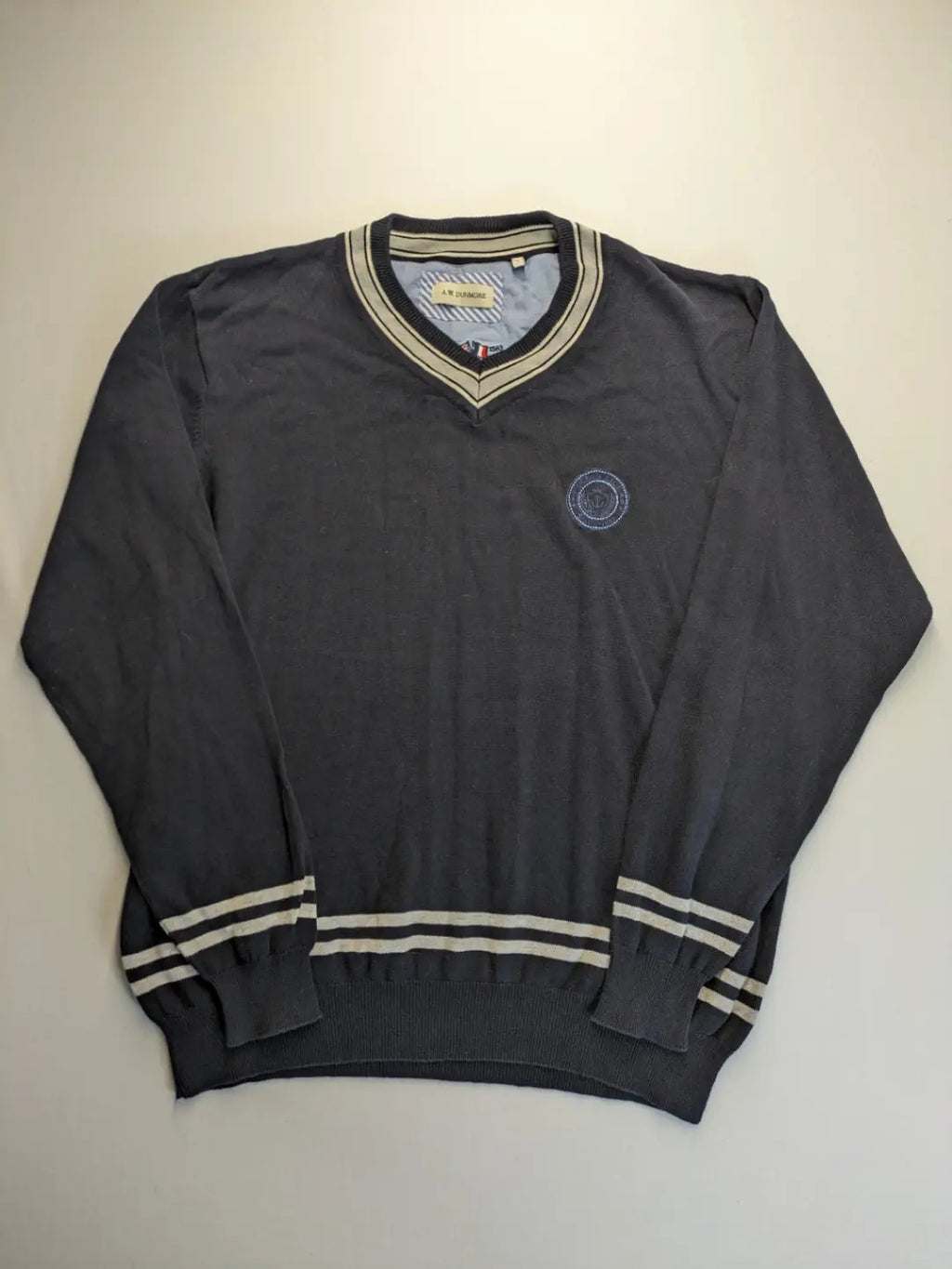 dunmore turtle neck jumper dark blue with striped trims and embroidered crest logo