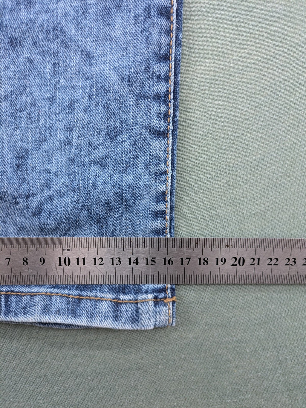 Janina blue slim fit jeans with acid wash, destroyed details, and button fly.