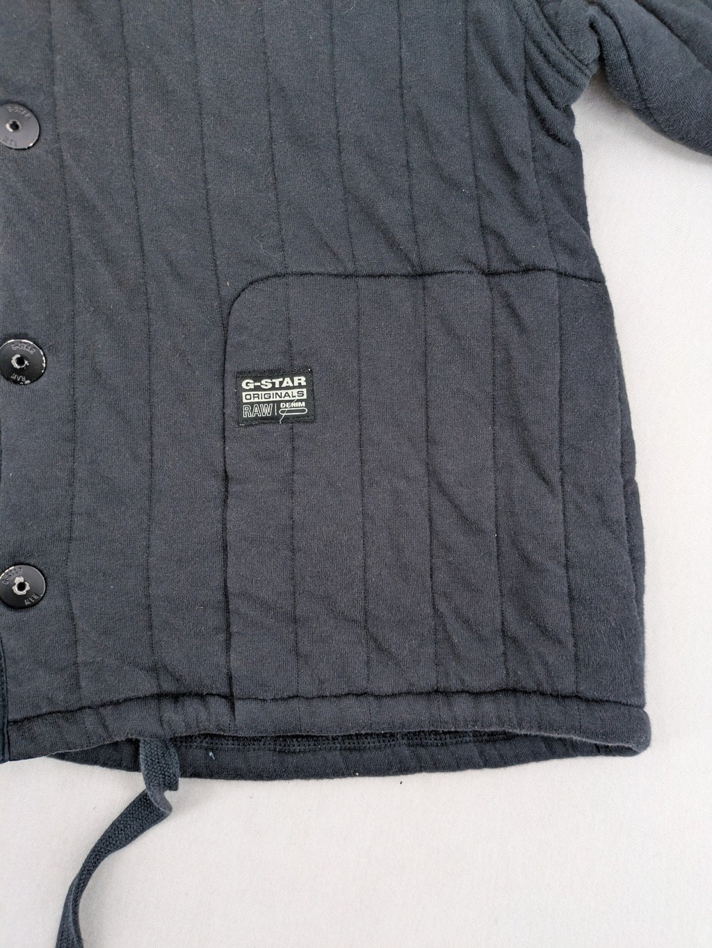 G-Star Raw grey quilted jacket with button closure and adjustable drawstring hem.