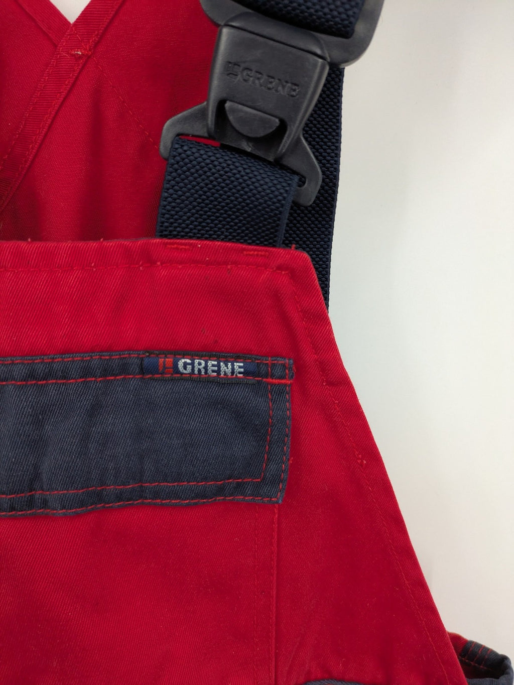 Grene navy red overall with adjustable straps, multiple pockets, and durable material.