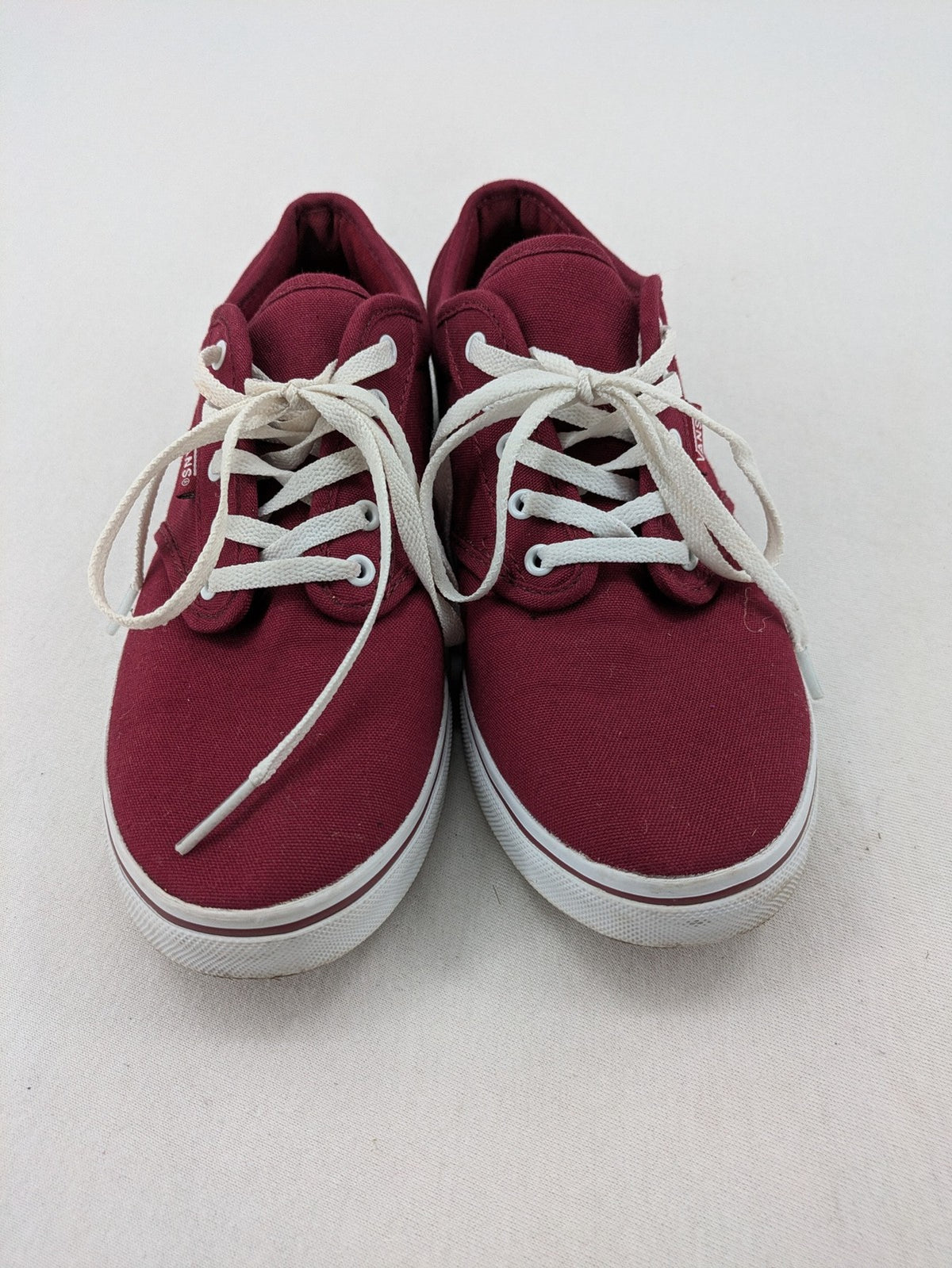Vans low-top sneakers burgundy canvas with white logo and classic waffle sole.