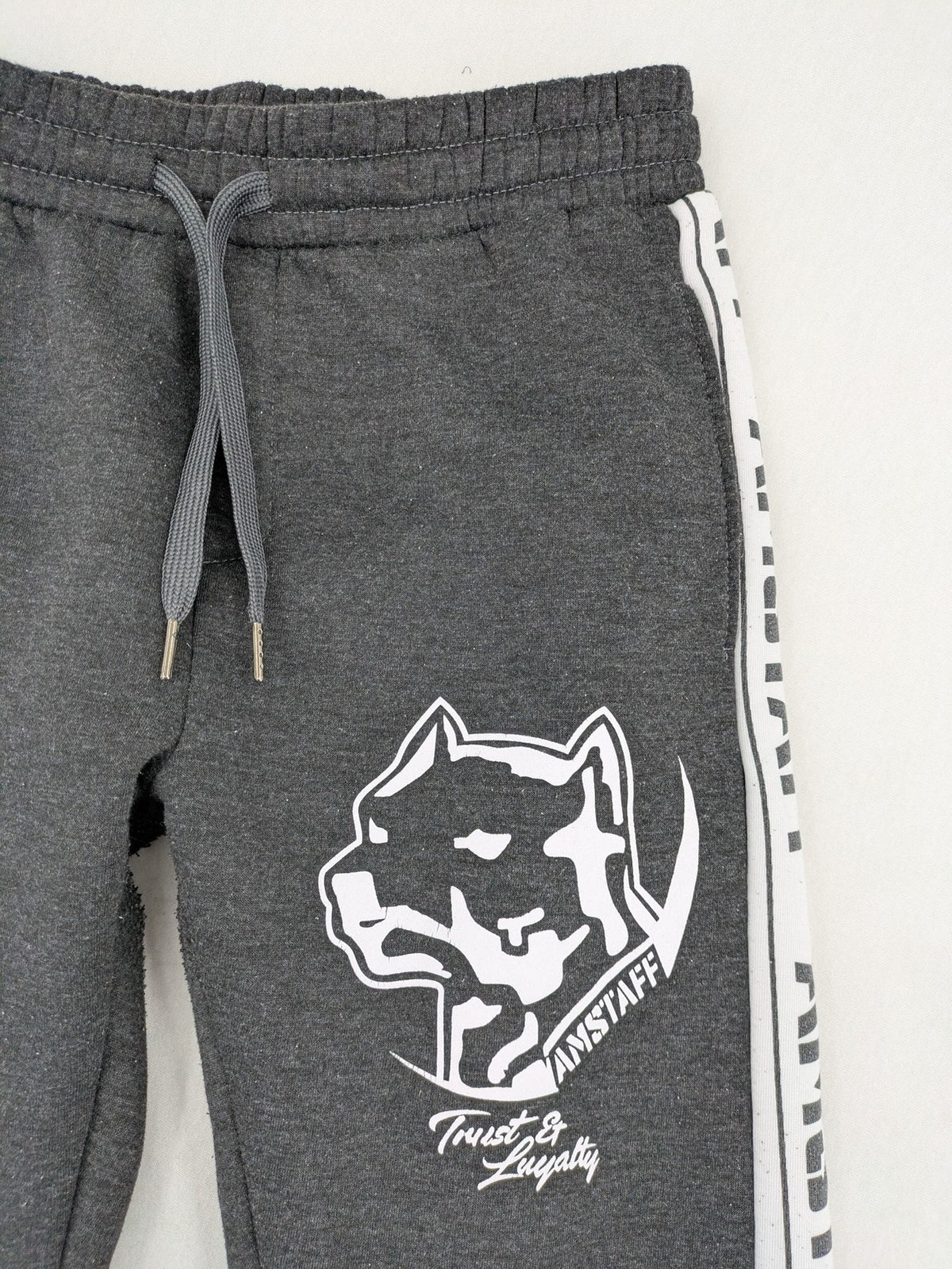Amstaff grey sweatpants with large dog logo and "Trust & Loyalty" text.