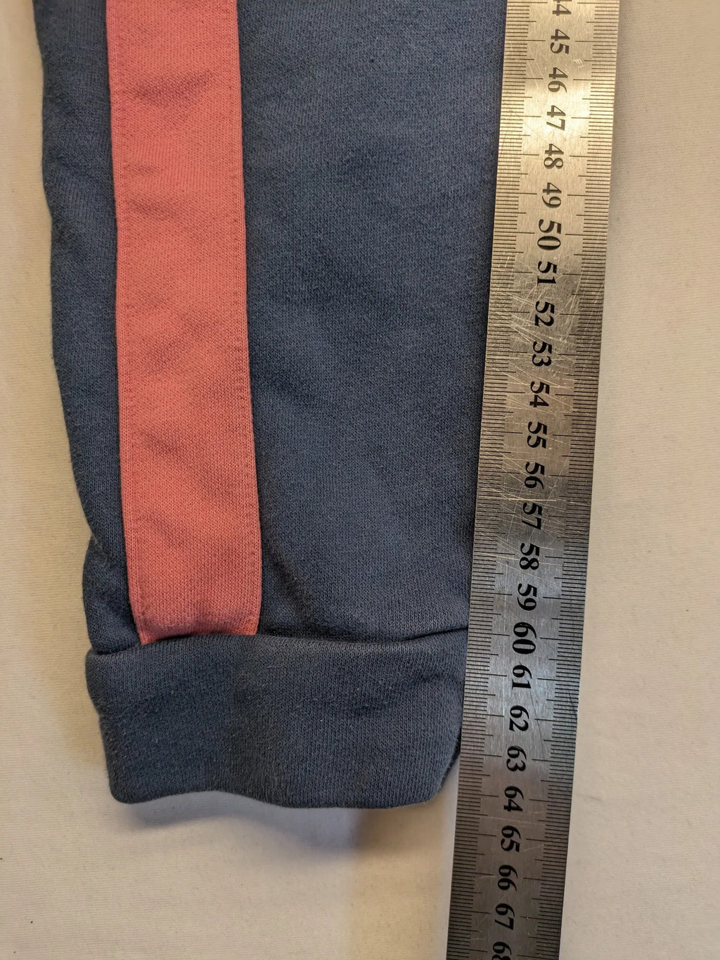 Adidas grey joggers with pink stripes and iconic logo on thigh.