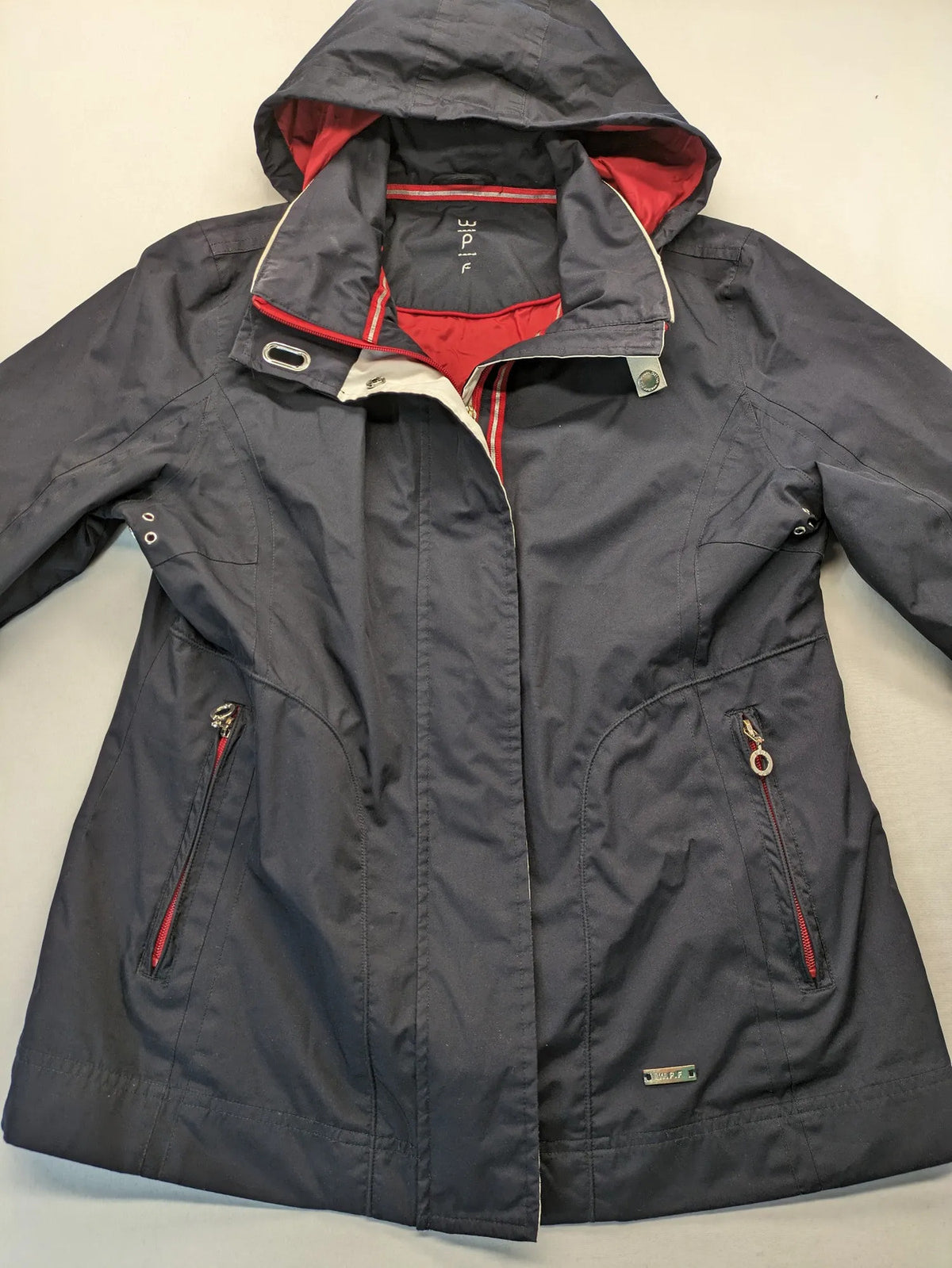 WPF grey outdoor jacket with red lining, zip closure, and hood.