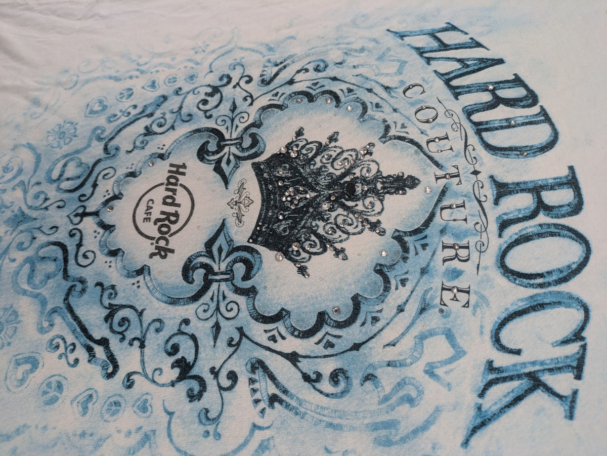 Hard Rock Cafe blue and white T-shirt with crown graphic and rhinestone accents.