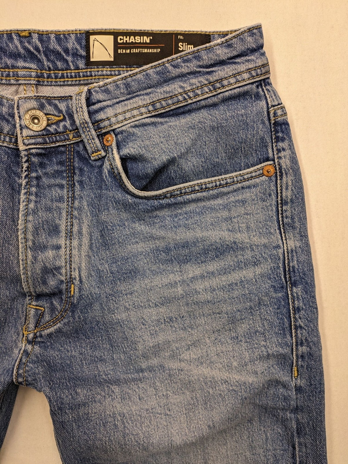 CHASIN' blue slim fit jeans with button fly and classic denim craftsmanship.