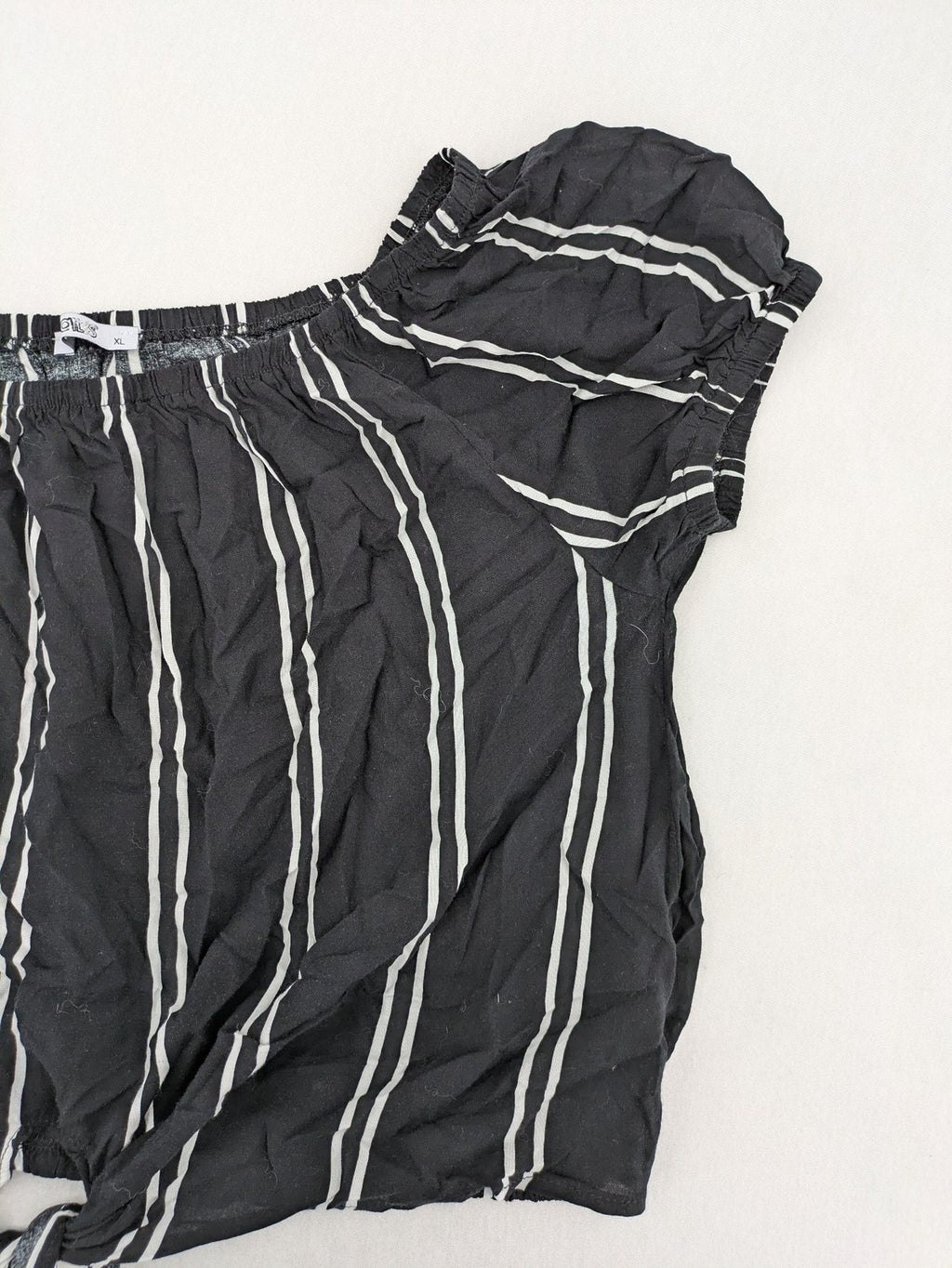 Hailys black and white striped crop top with front tie and off-shoulder design.