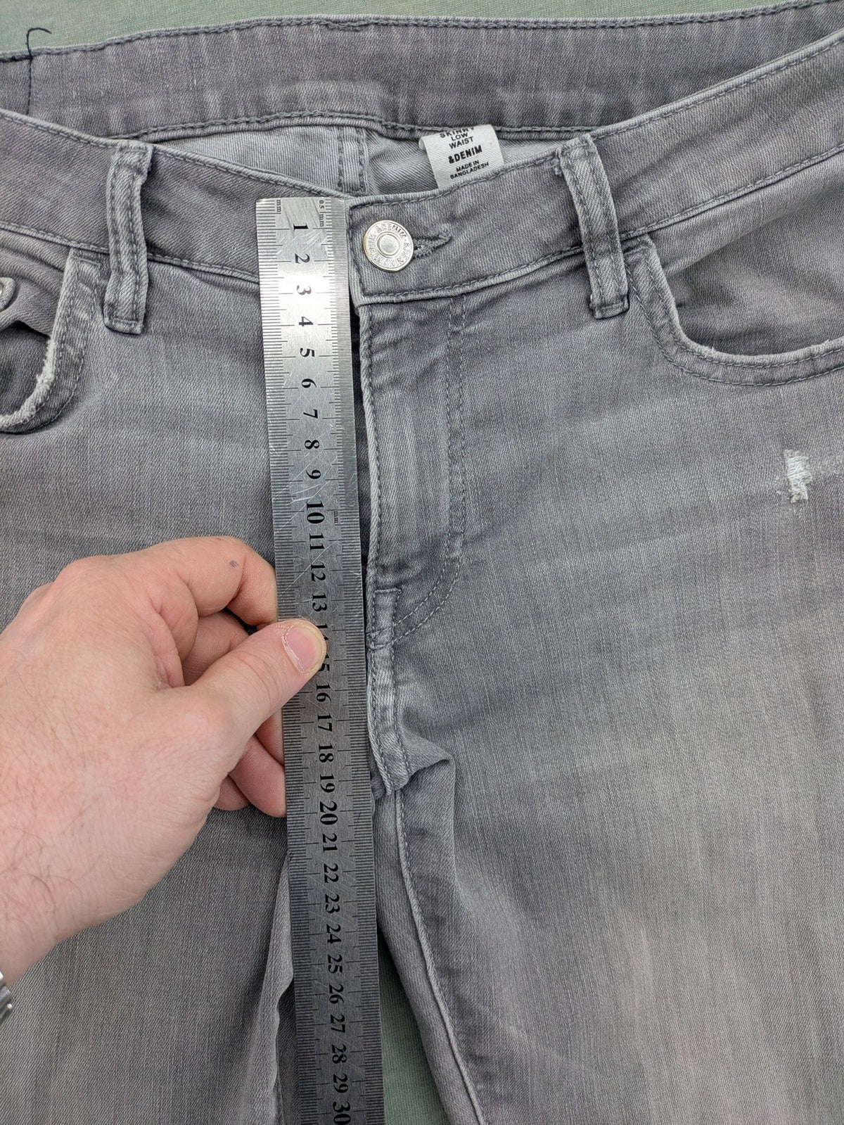 H&M grey super skinny jeans with distressed knee details and low waist fit.