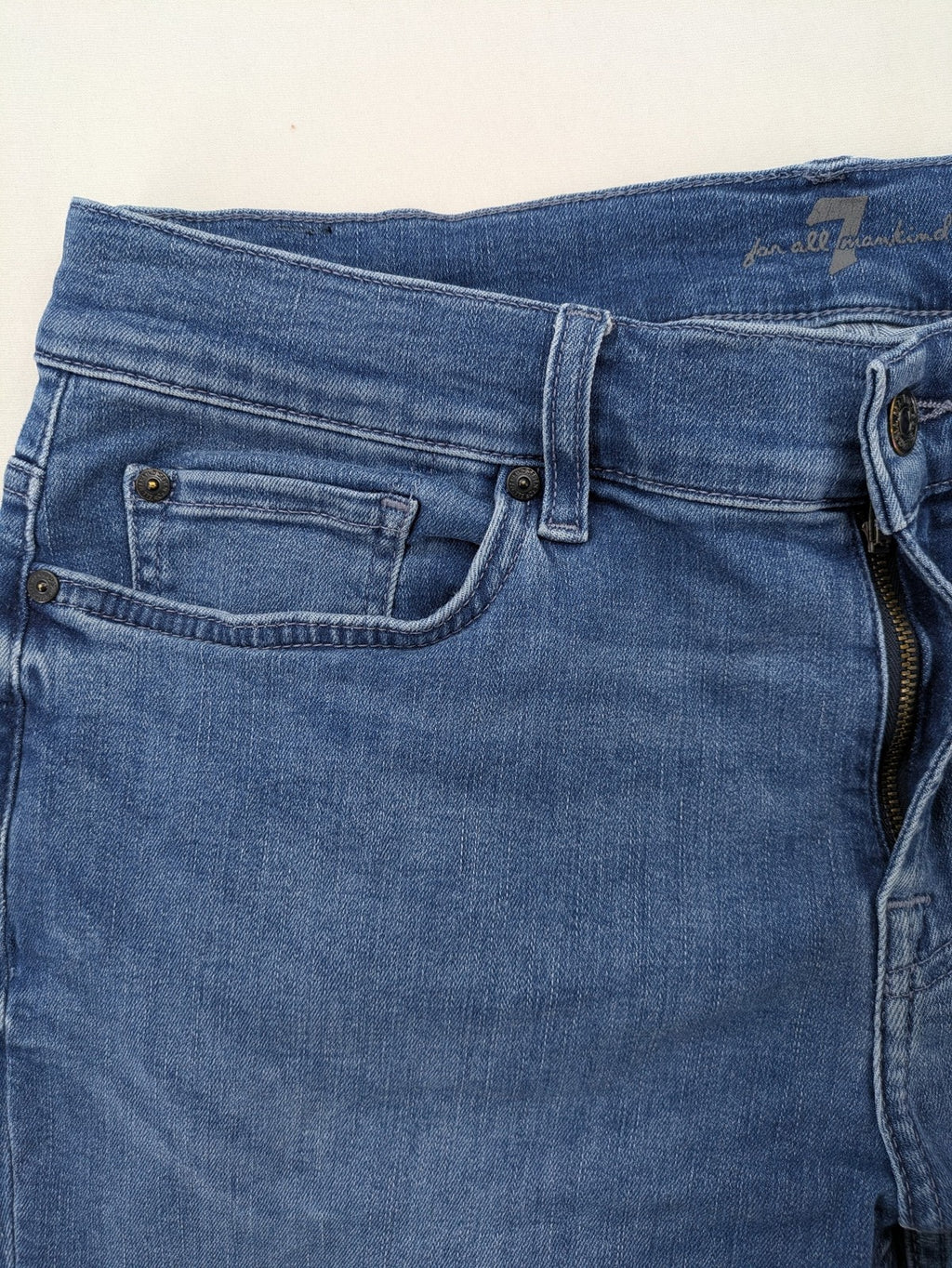 7 For All Mankind blue straight jeans with 5-pocket design and logo on back pocket.