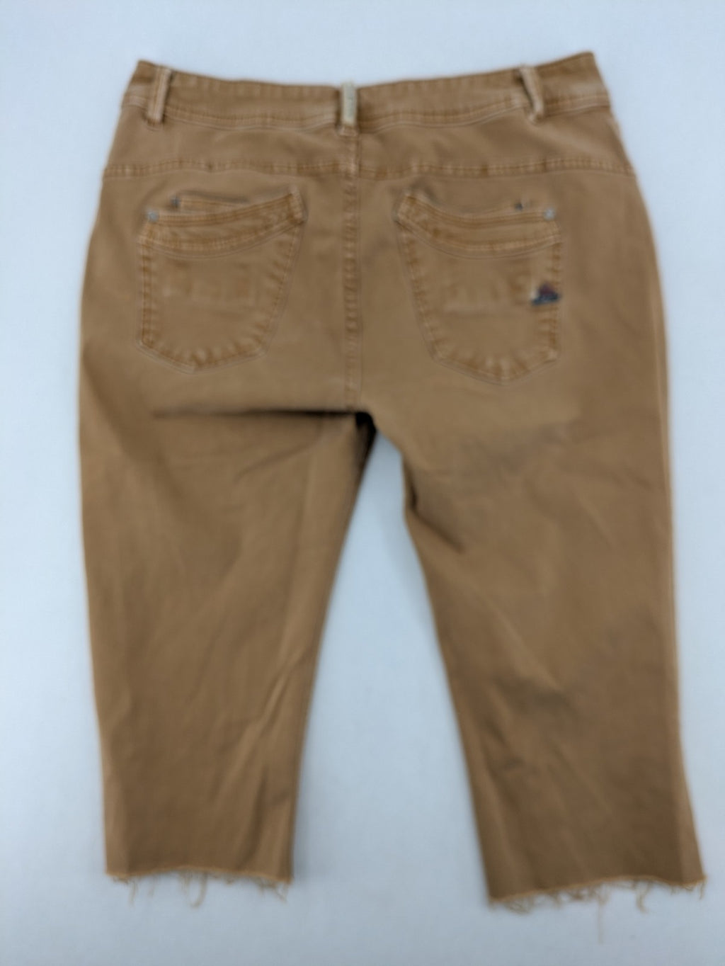 Buena Vista beige capri jeans with frayed hem and button fly detail.