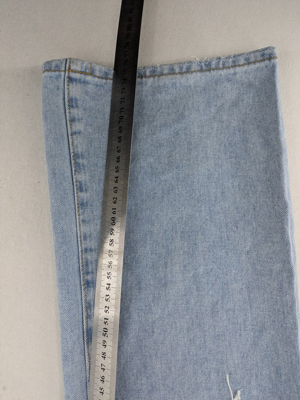 Laulia blue wide leg jeans with distressed knee rips and high waist design.