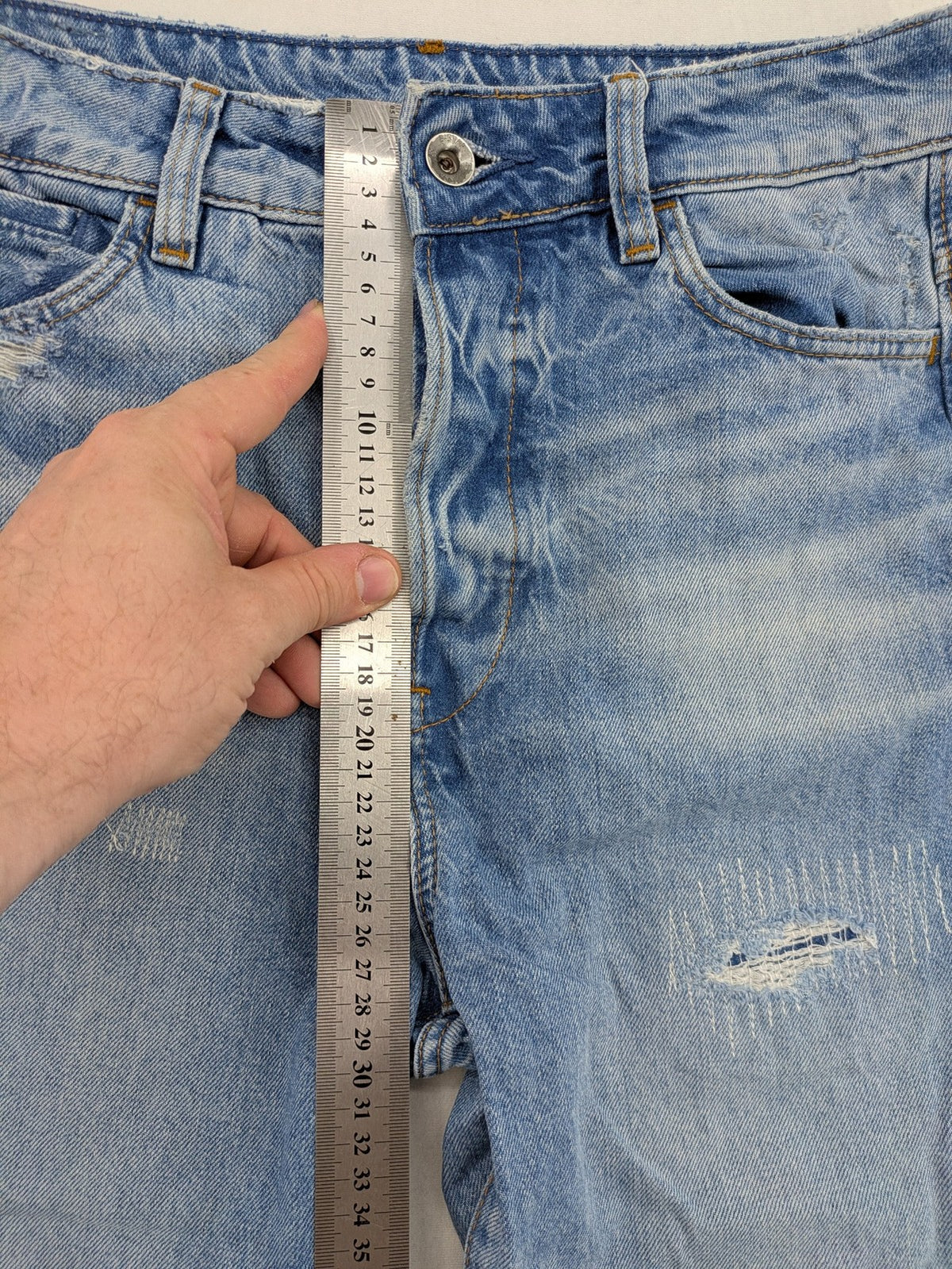 G-Star Raw blue distressed high boyfriend jeans with ripped details and classic button closure.