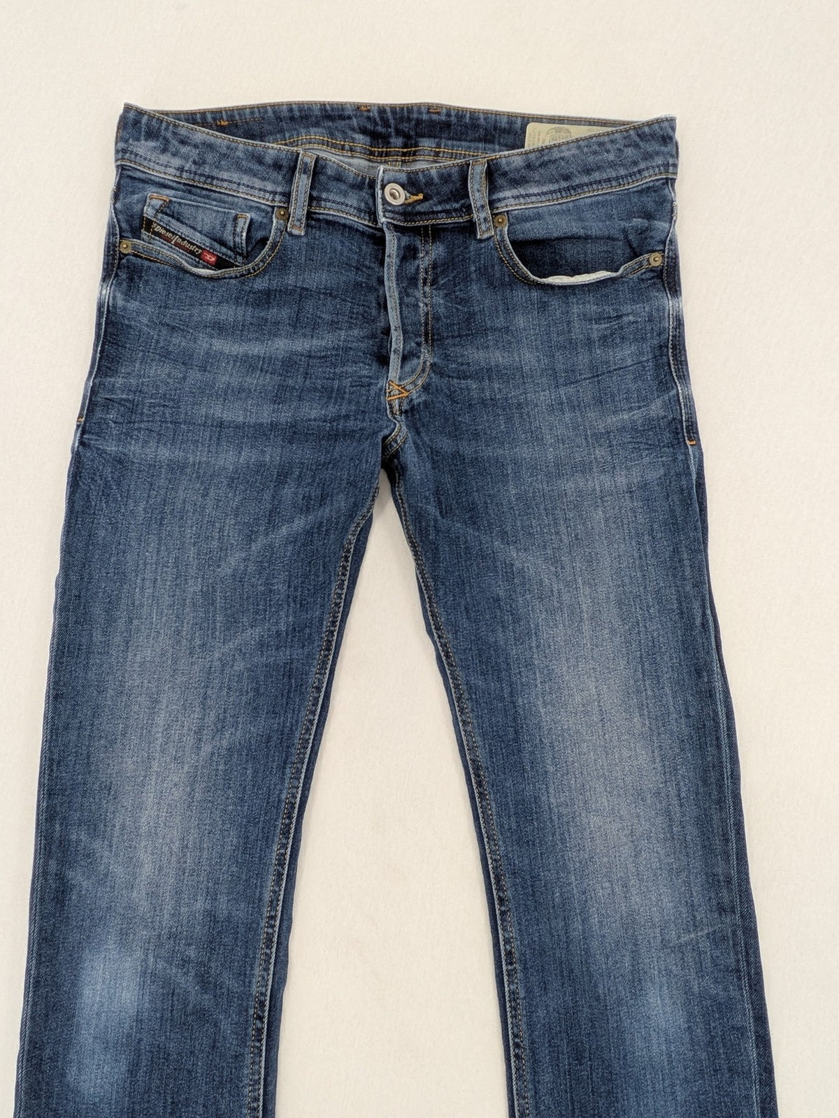 Diesel blue slim skinny jeans with logo patch and stretch denim material.