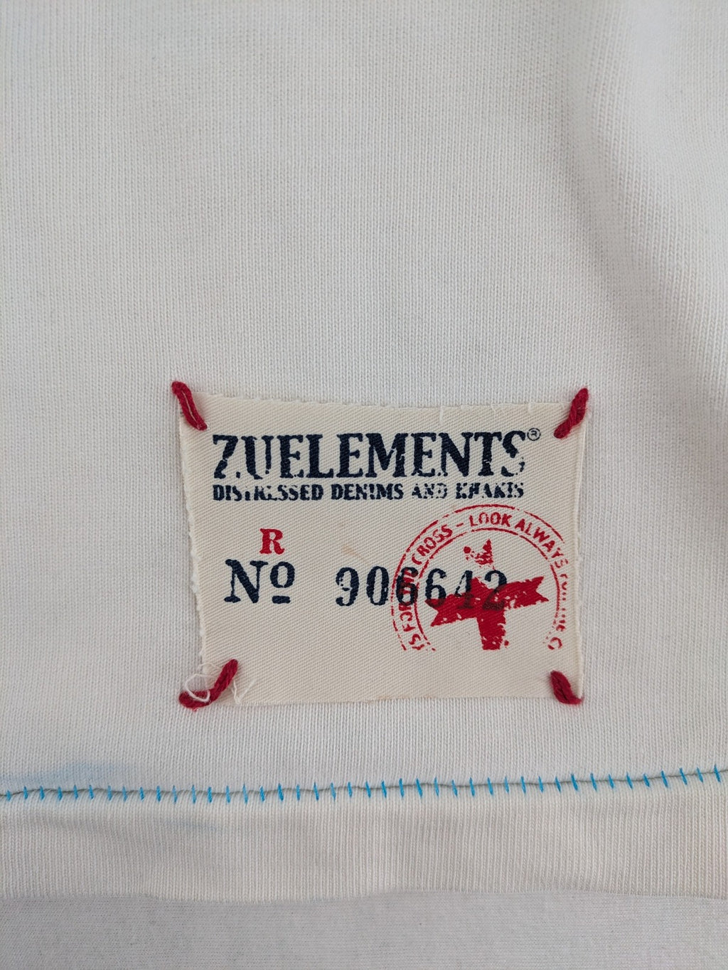 Zuelements black turtle neck jumper with red wing graphic and large blue logo.
