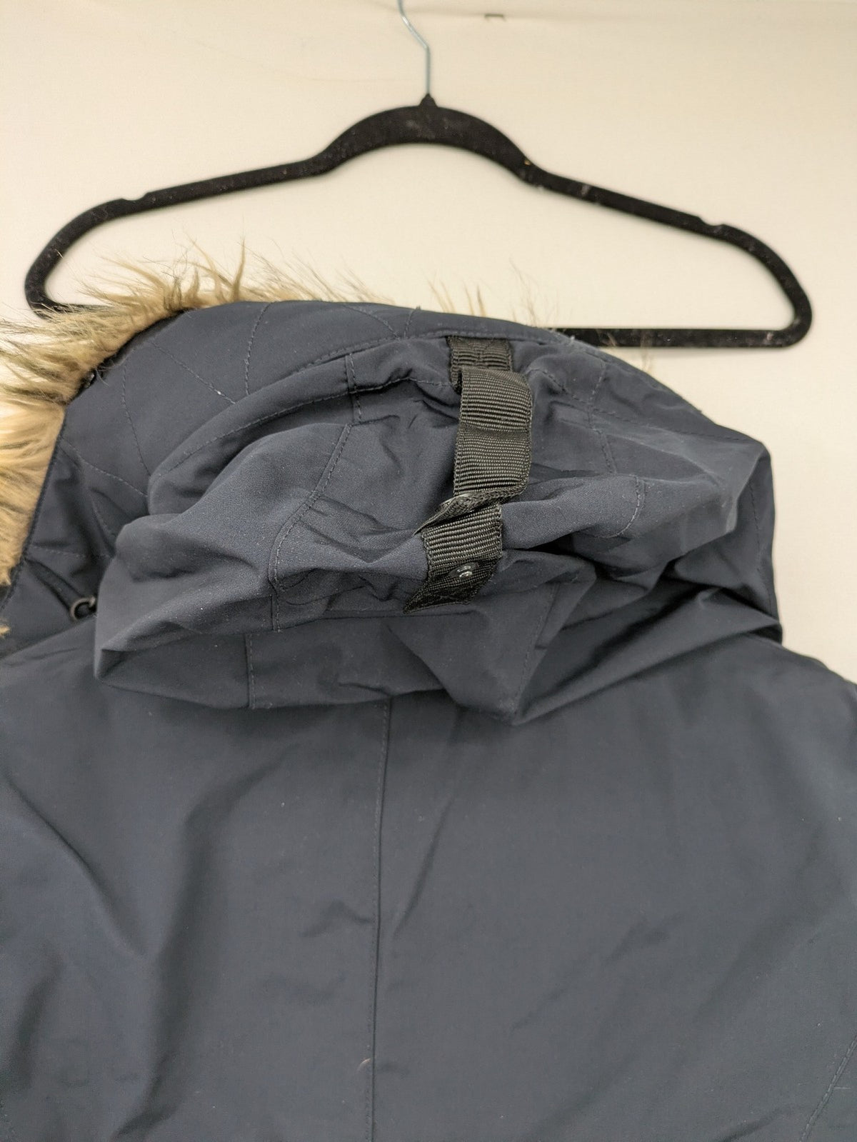Reset Fifty Seven cream puffer coat with faux fur hood and down insulation.