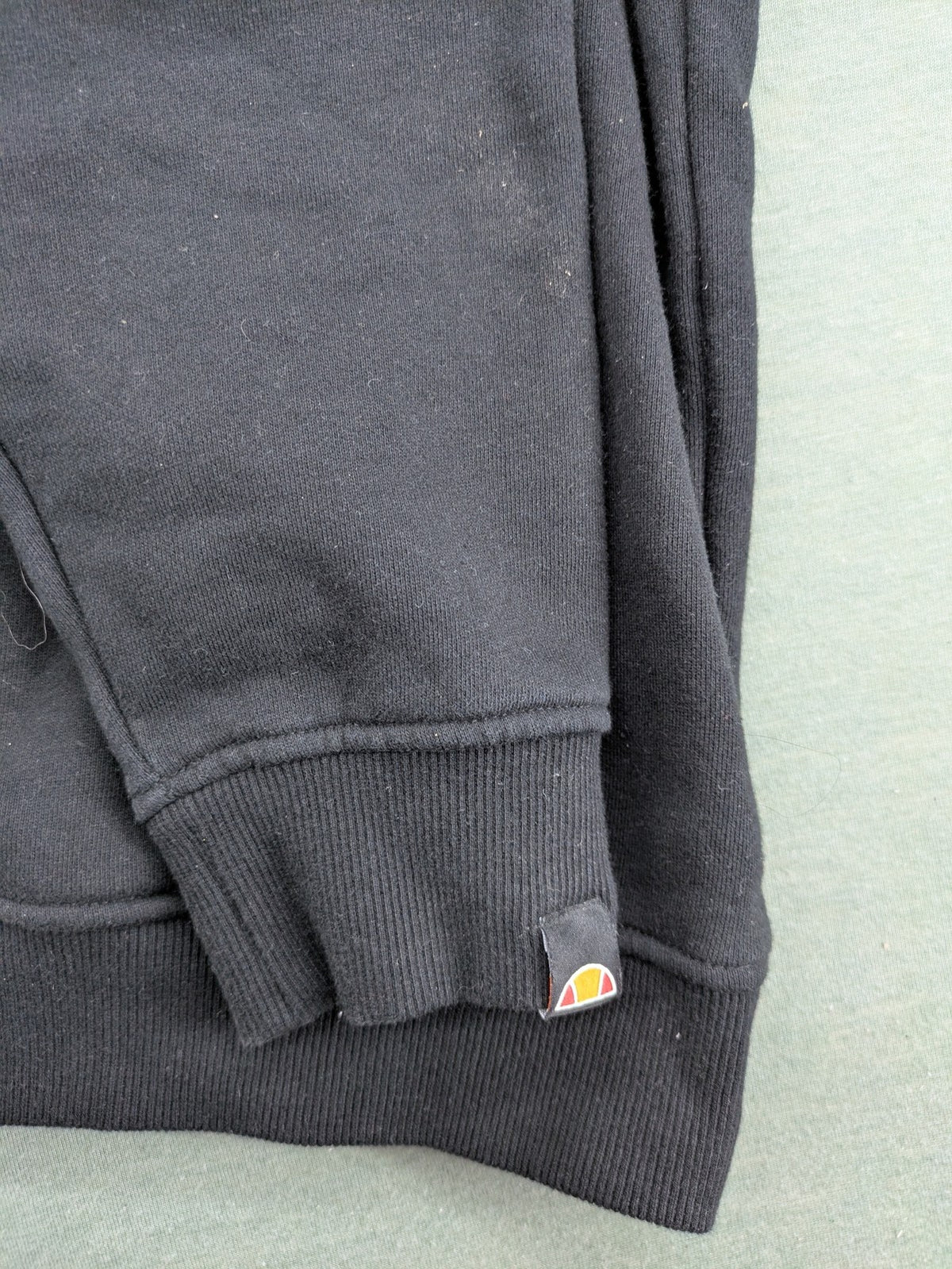 Ellesse grey hoodie with large logo, kangaroo pocket, and drawstring hood.