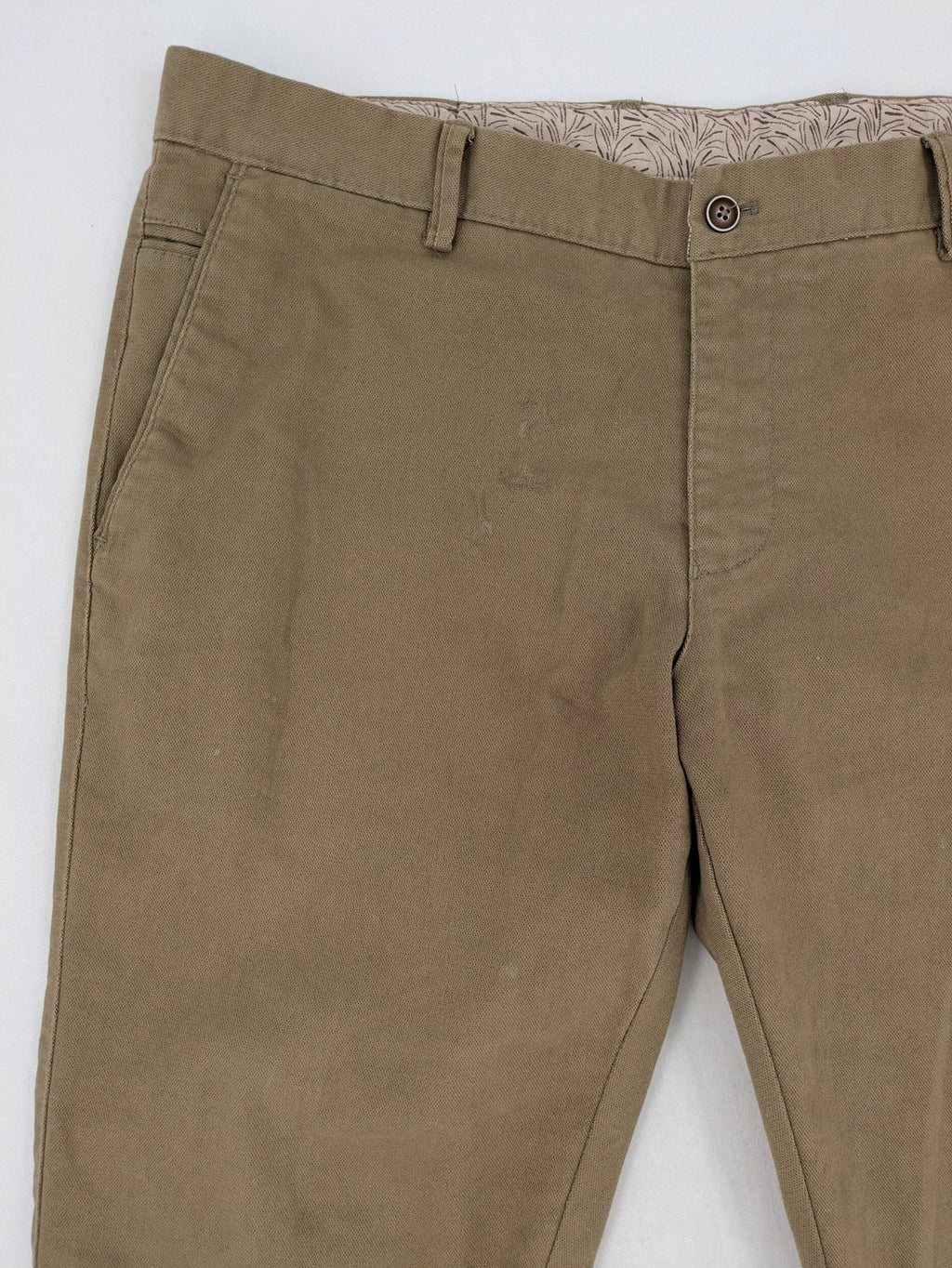 Süvari khaki chino pants flat-front design with patterned waistband detail, cotton blend material.
