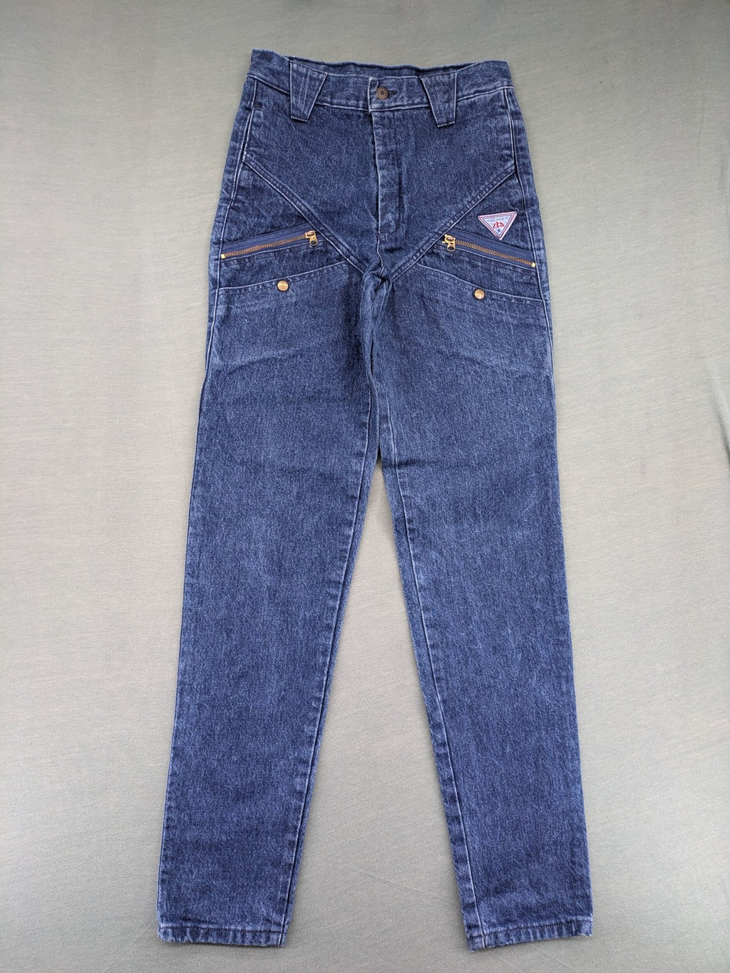 YKK blue high waist mom jeans with decorative front zipper pockets and vintage denim texture.