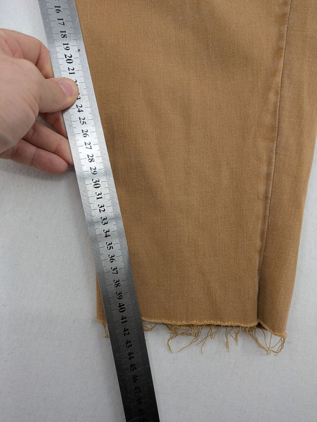 Buena Vista beige capri jeans with frayed hem and button fly detail.