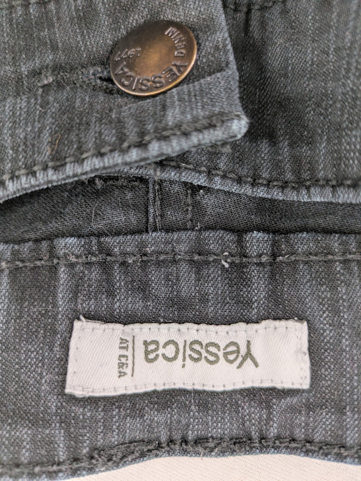 Yessica black straight jeans with classic dark wash and stretch denim material.