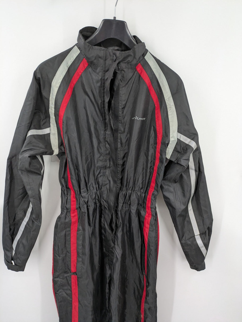 Unitech black rain suit with red reflective stripes and full zipper, size M.