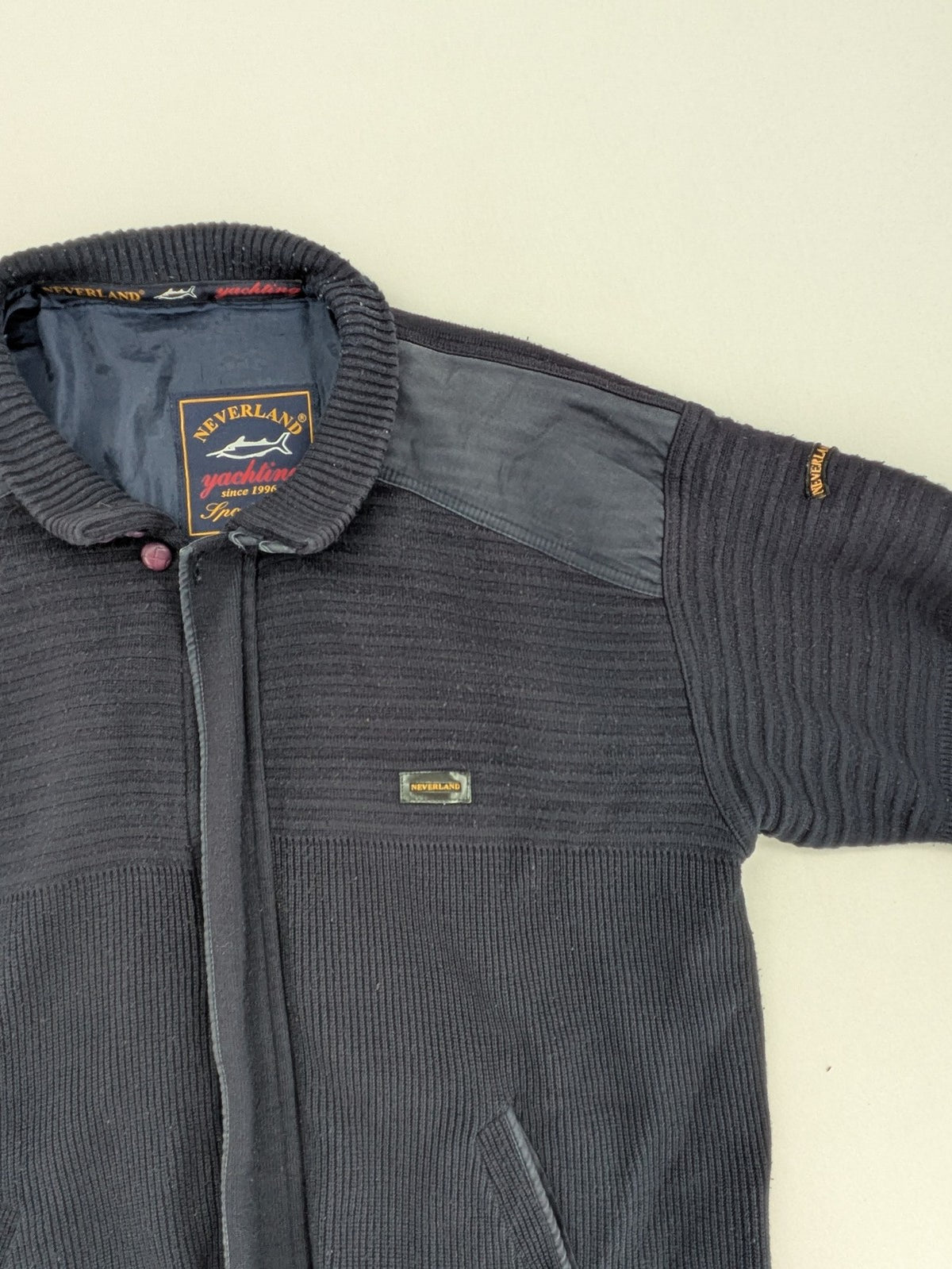 Neverland grey and navy full zip turtle neck jumper with ribbed knit and shoulder patches.