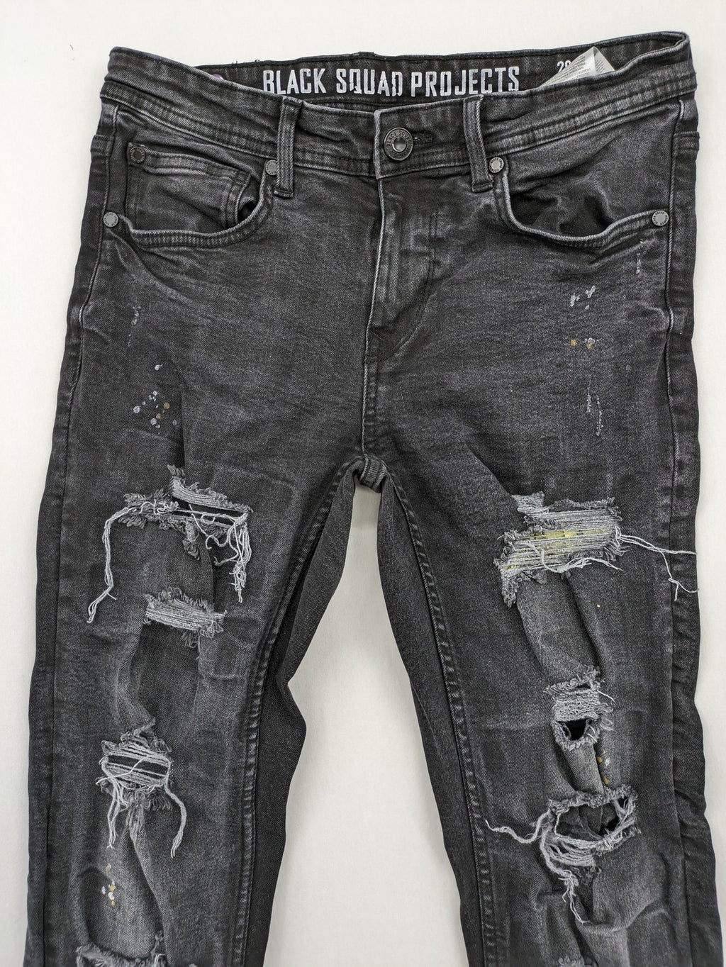 Black Squad skinny fit jeans black distressed ripped design with subtle paint splatter.