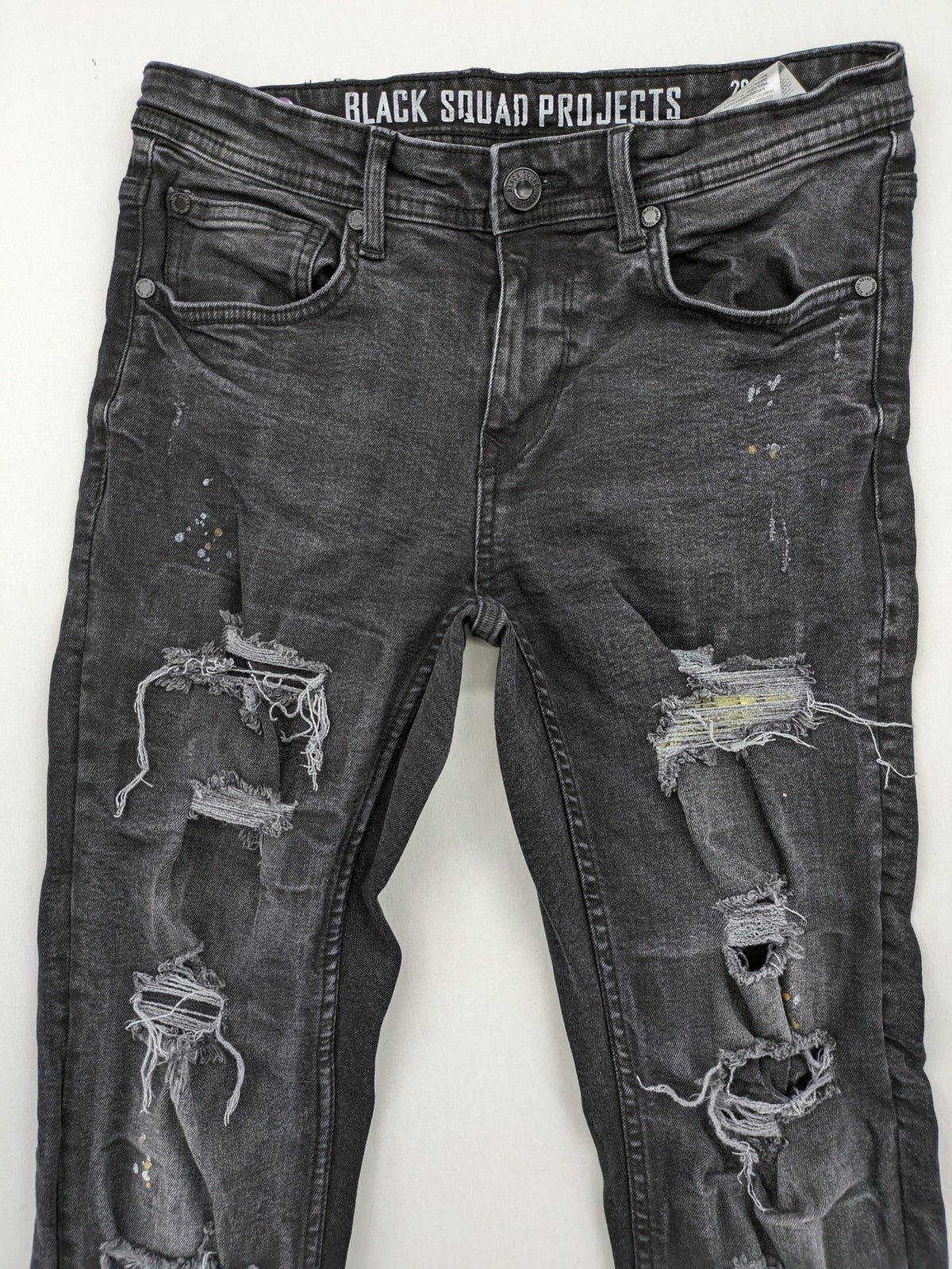 Black Squad skinny fit jeans black distressed ripped design with subtle paint splatter.