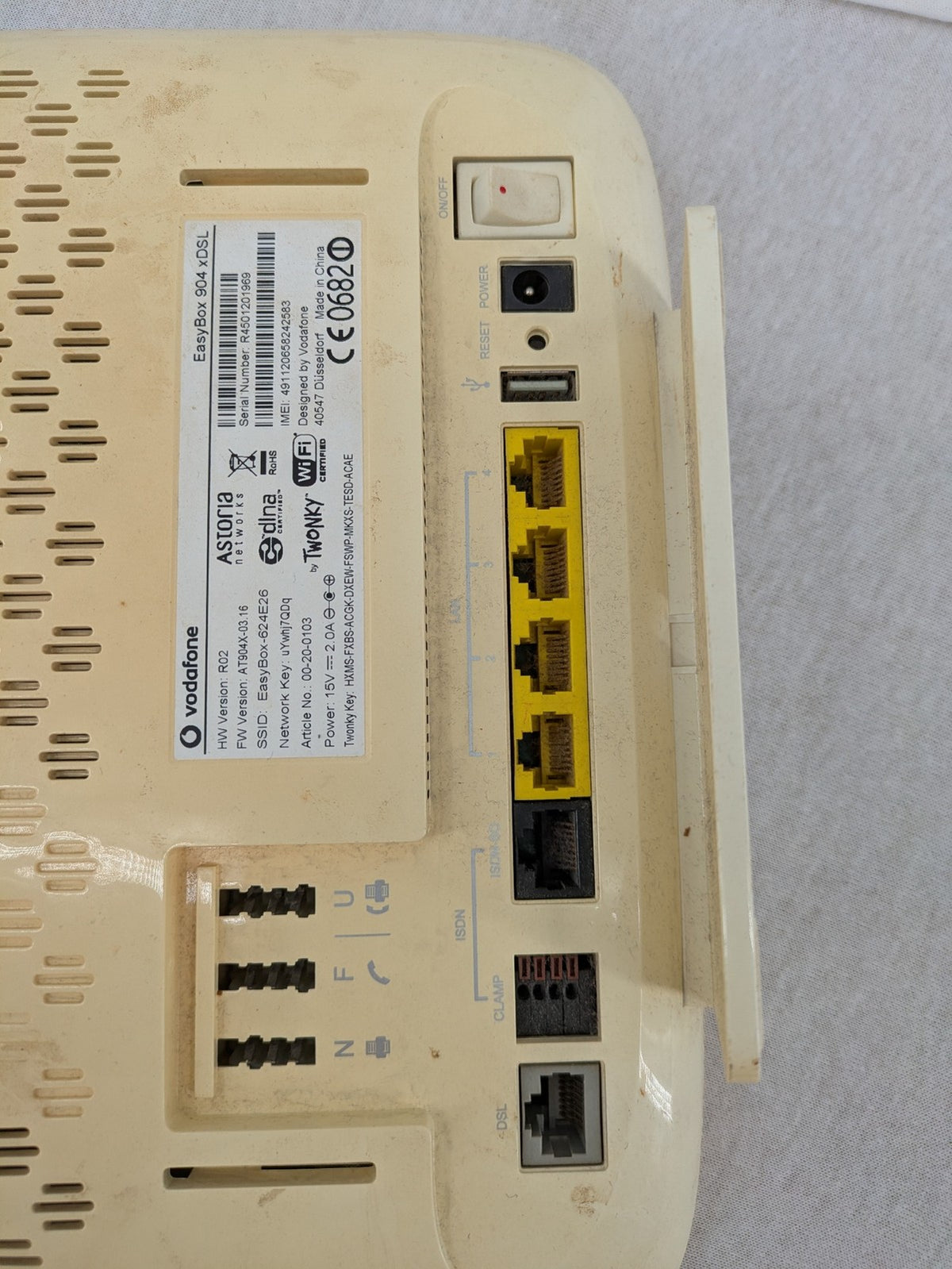 Vodafone beige wireless router with multiple LAN ports and DSL connectivity.