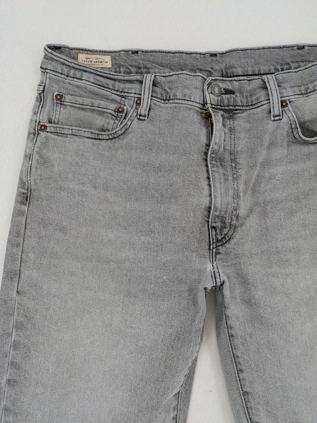 Levi's grey slim fit jeans with distressed knee details and classic logo patch.