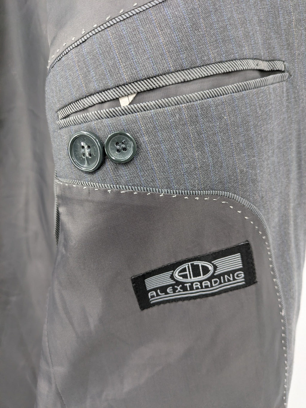 Alextrading grey jacket with subtle light blue pinstripe pattern and notch lapels.