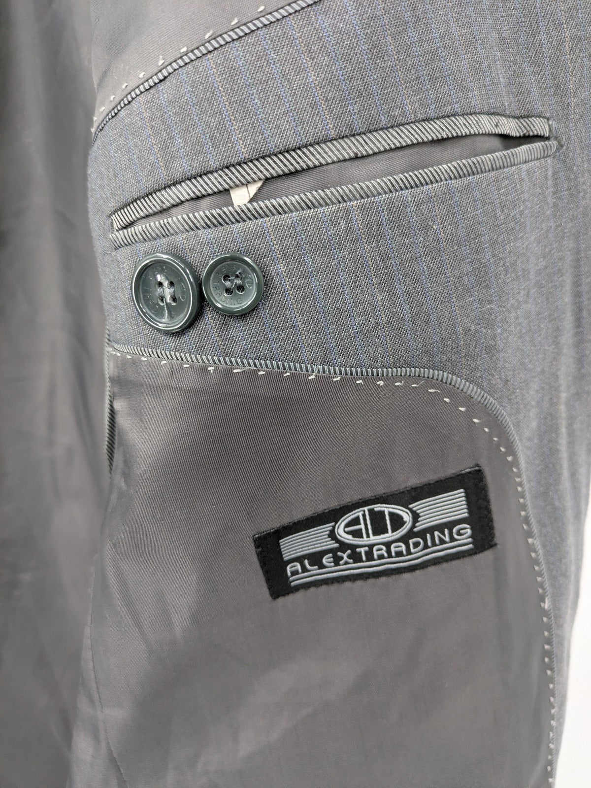 Alextrading grey jacket with subtle light blue pinstripe pattern and notch lapels.