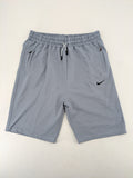 Nike grey shorts with Dri-FIT technology, elastic waistband, and zippered pockets.