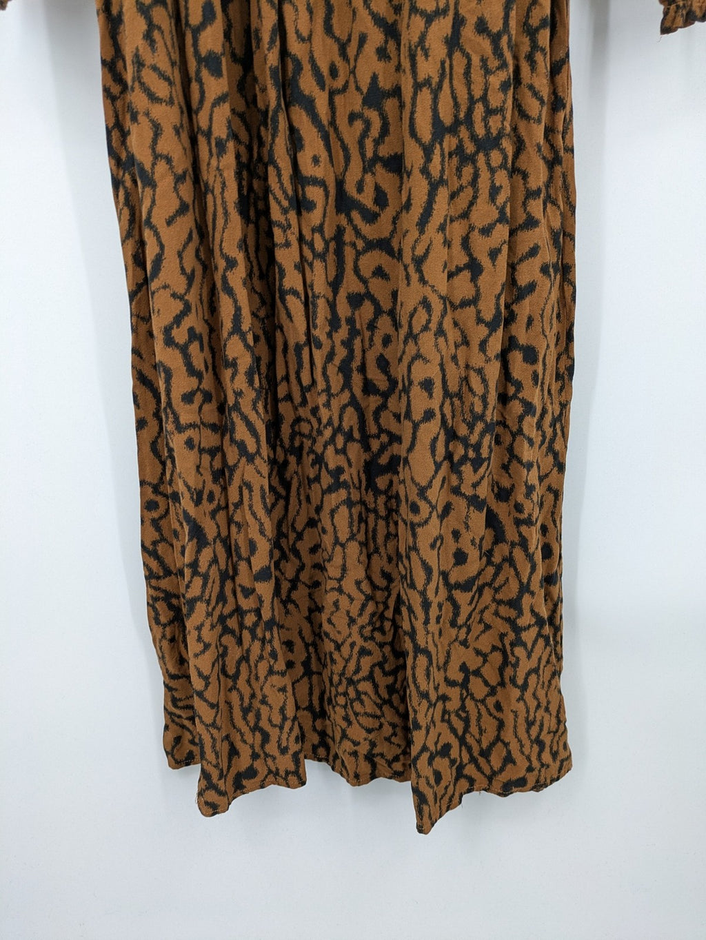 H&M brown and black animal print midi dress with smocked bodice and square neckline.