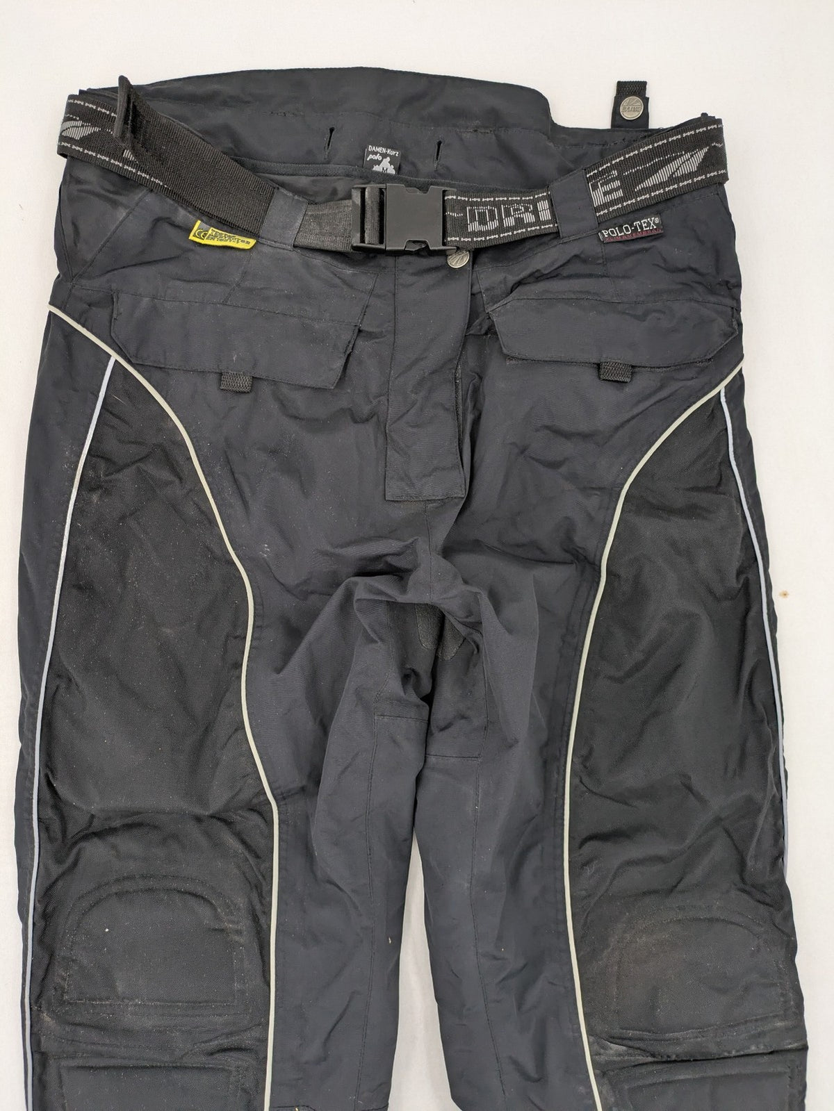 Polo black chaps with grey and white accents, featuring protective knee pads and adjustable belt.