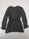 Bella black wrap blouse with deep V-neck and ruffled long sleeves.