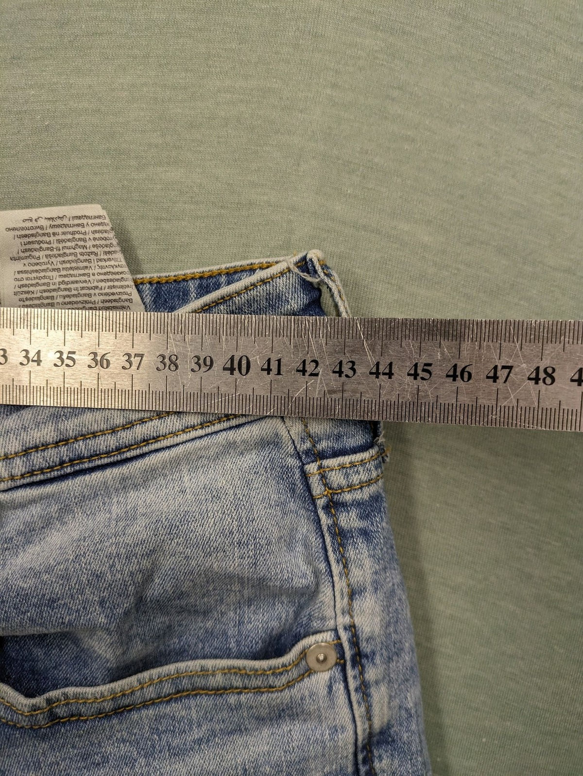 Jack & Jones blue slim fit jeans with button fly and light wash denim texture.
