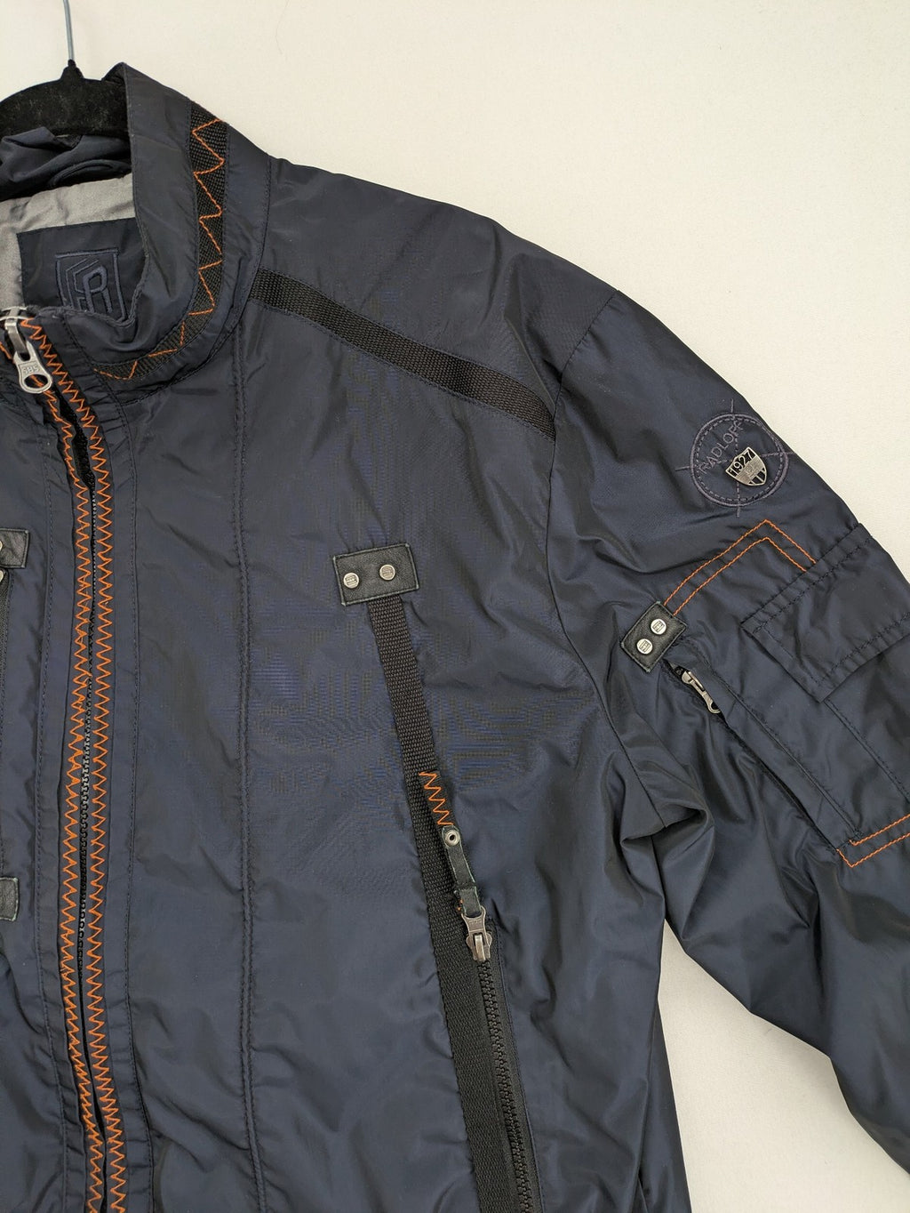 Radloff grey navy bomber jacket with orange contrast stitching and zippered pockets.