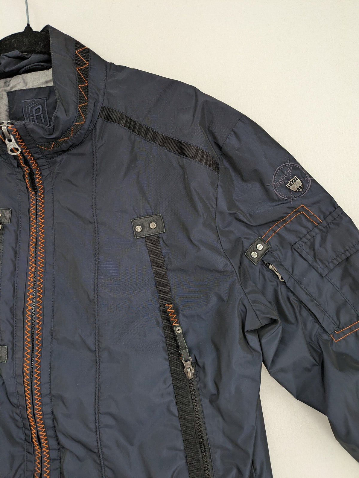 Radloff grey navy bomber jacket with orange contrast stitching and zippered pockets.