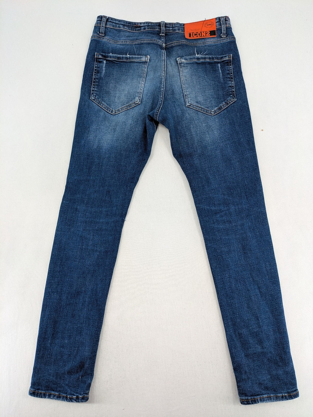 ICON 2 blue slim fit jeans distressed stretch denim with button fly and faded details.