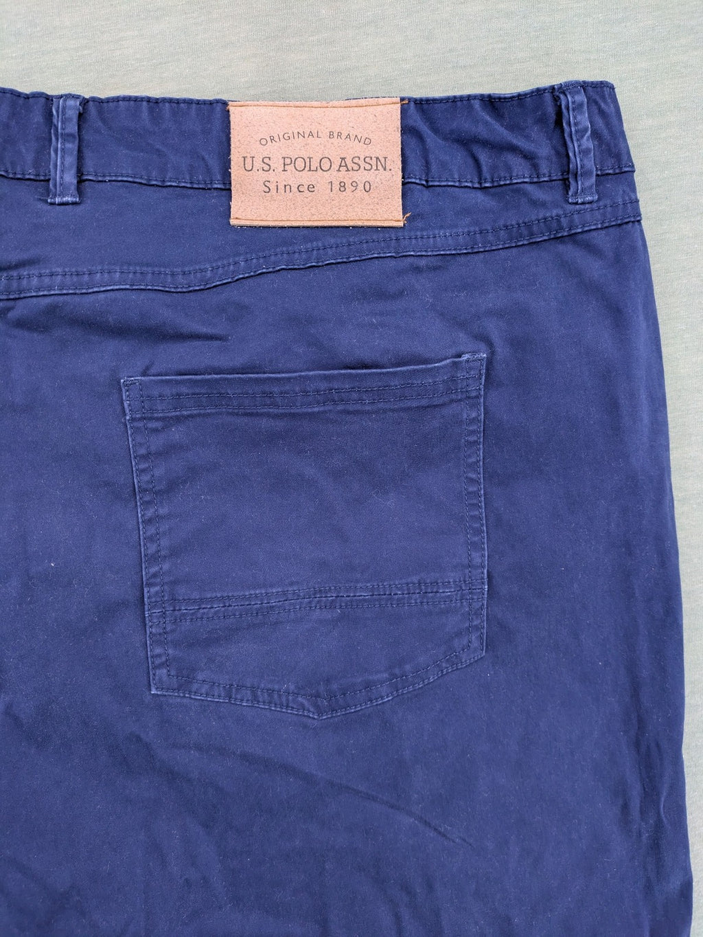 U.S. Polo Assn. navy chino pants classic 5-pocket design with subtle logo stitching