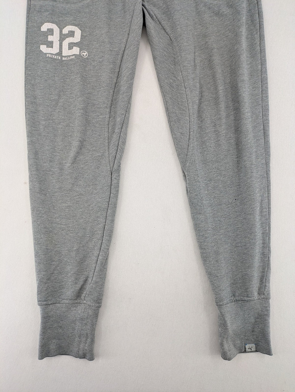 Private Baller grey sweatpants with "32" graphic print and blue drawstring.